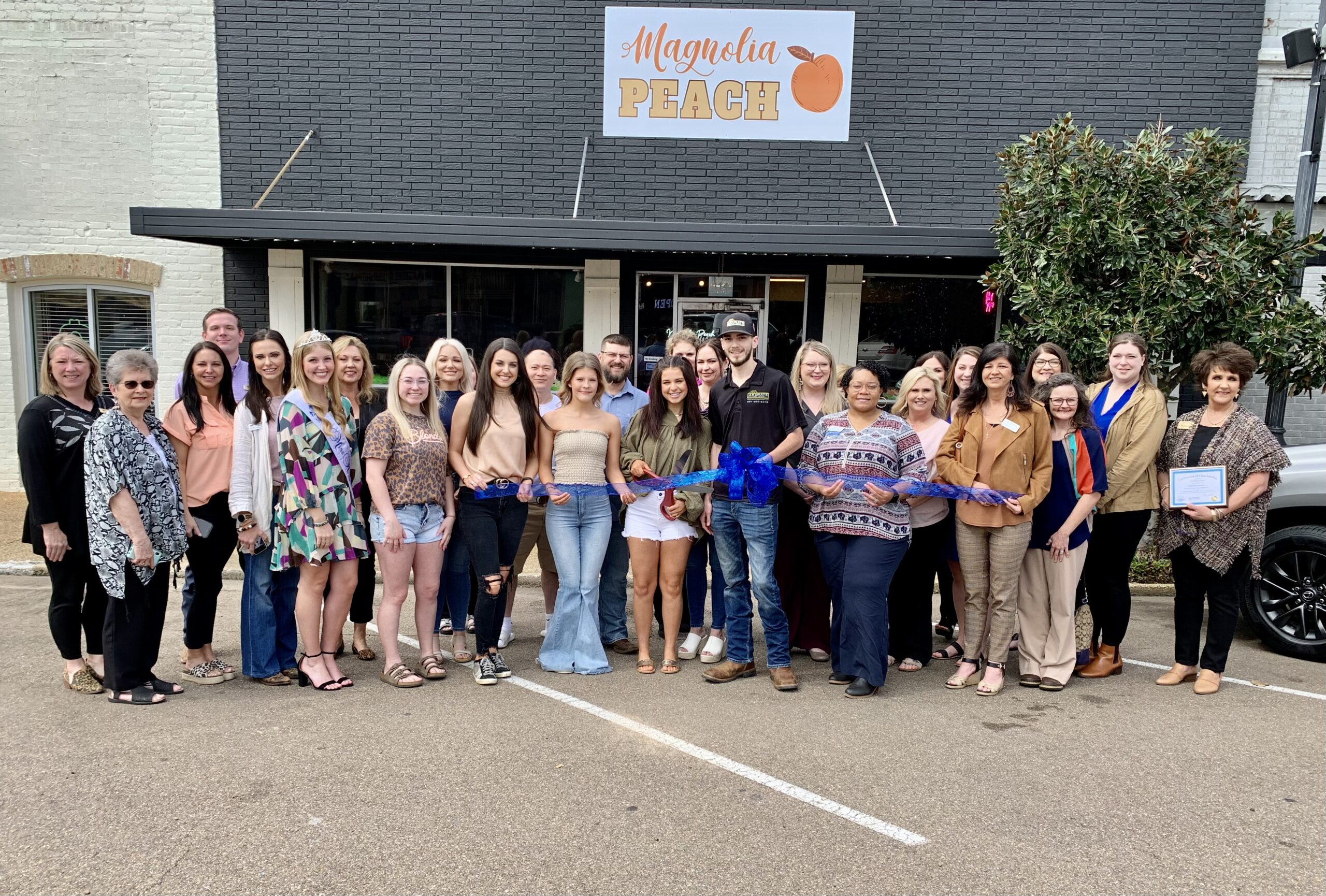 Magnolia Peach Holds Ribbon Cutting