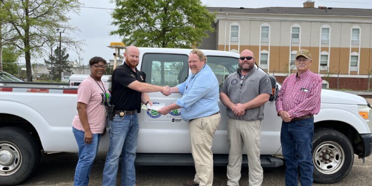 Commissioner Busby presents six litter removal vehicles to county sheriff’s departments